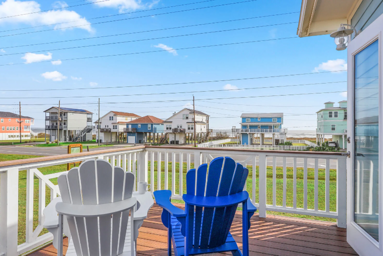 Lovely master suite with double doors opening to deck with ocean view, and modern en-suite bath.