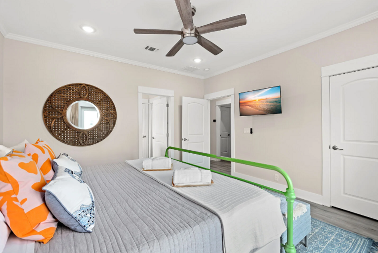 Master bedroom with double doors that open to the deck, with an ocean view. Streaming TV