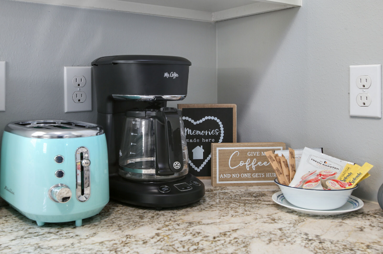 A coffee station will be set up with 2 packs of coffee that make 10-12 cups each, sugar, sweetener, and creamer, (as shown).