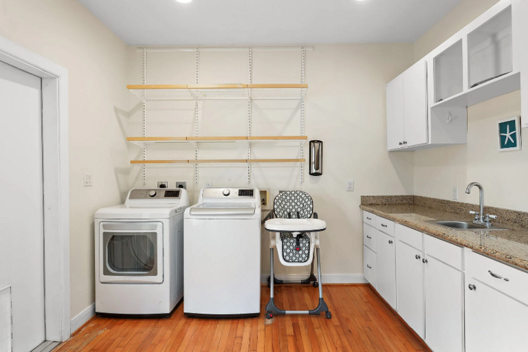 Check out this big utility room with washer, dryer, sink and refrigerator.