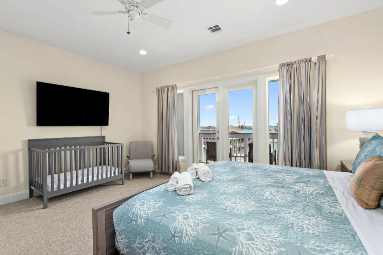 Comfy King bed, crib, streaming TV, and private balcony overlooking the water