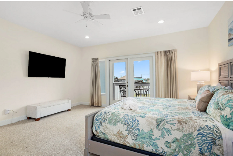 Comfy King bed, streaming TV, and private balcony overlooking the water.
