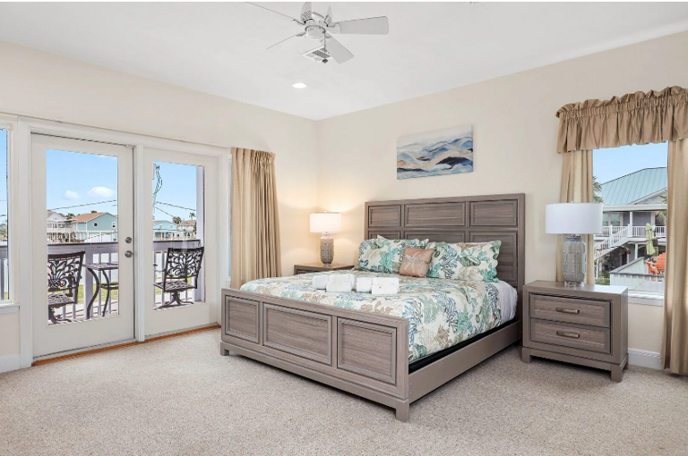 Comfy King bed, streaming TV, and private balcony overlooking the water.