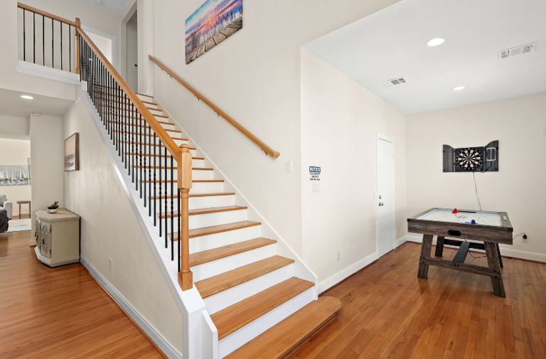 Stairs up go to bunk/living area, bunkroom, king bedroom with private balcony with water view, and streaming TV, two full baths.