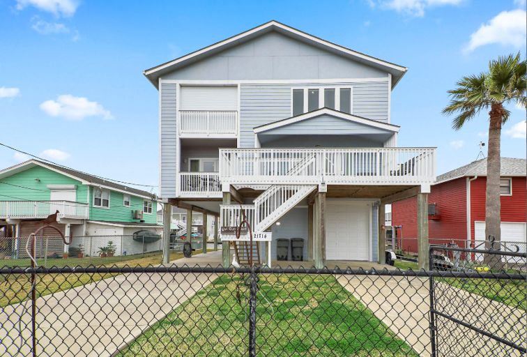 Stairs up to front doors.  Two balconies shown are off two of the King bedrooms.Partially fenced yard.