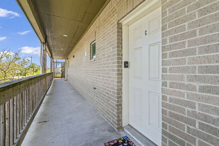Front door is located above the Exxon gas station; there are stairs on either side of the building.