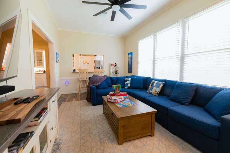 Large Couch, Smart TV, and Barstool Seating for 2