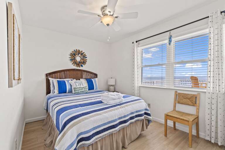 Wake up to ocean views in this bright, cozy beach bedroom — pure relaxation awaits.