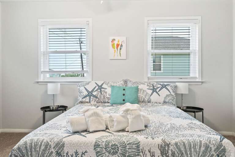 Comfortable queen bedroom with fresh linens and coastal style.