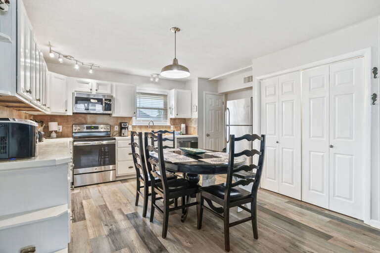 Fully equipped kitchen with stainless steel appliances, ample cabinet space, and a comfortable dining area for family-style meals.