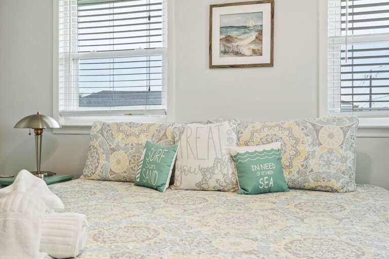 Plush king bed with fresh linen, perfect for a restful night after a day at the beach.