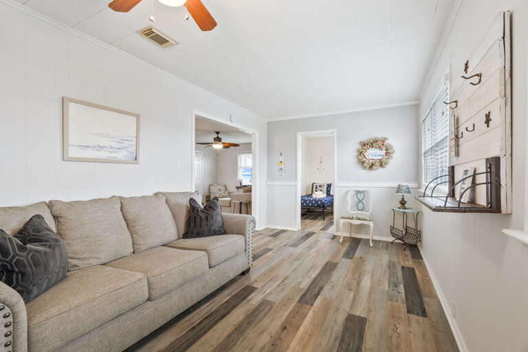 Relax in this light-filled room featuring cozy seating and charming beach-inspired touches.