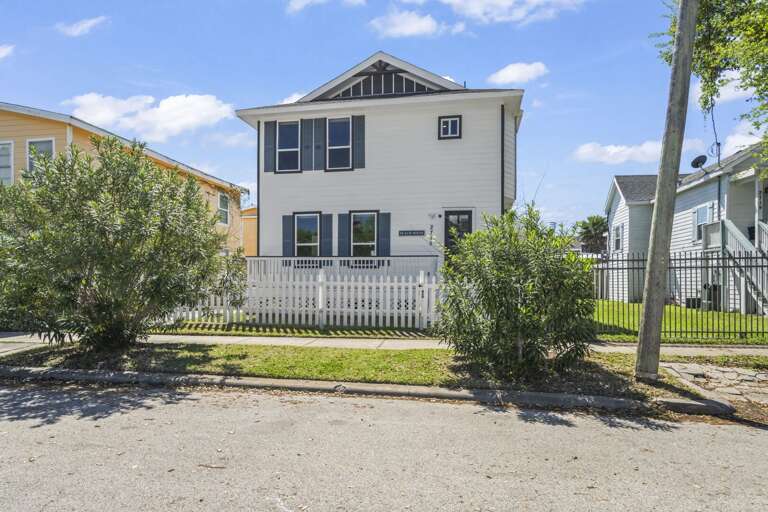 White Building, Black Shutters, Picket Fence, Sunny Street