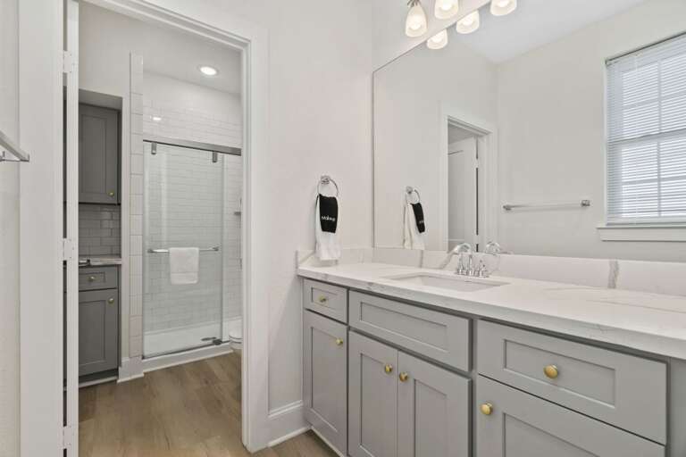 Stylish bathroom with a large vanity and walk-in shower for added comfort and convenience.