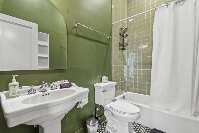 Stylish bathroom with bold green accents, classic fixtures, and a clean, refreshed feel.