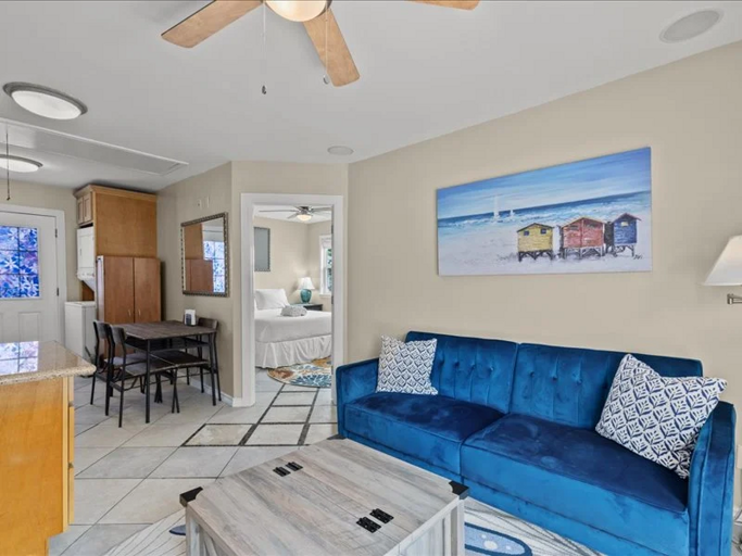 A bright and inviting living space with cozy seating, coastal touches, and easy access to the dining area.