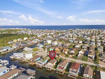 This aerial view showcases Garnele's Retreat's canal-side location with the Gulf just beyond the neighborhood.