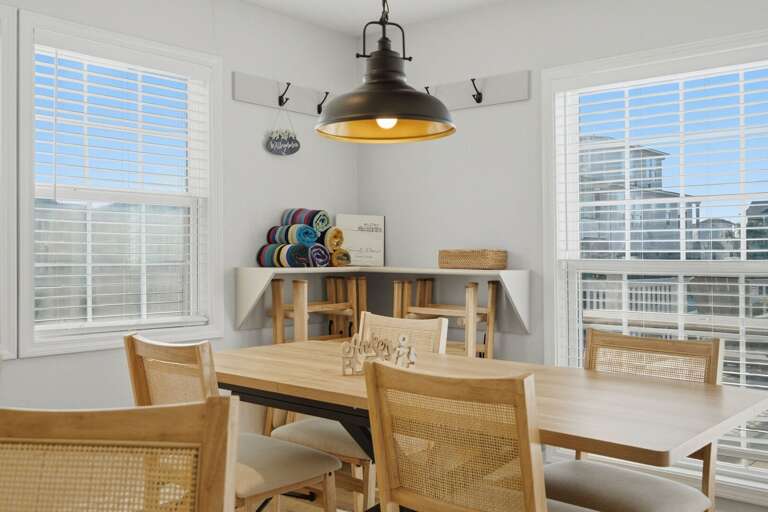 A bright dining area with plenty of natural light creates an inviting space for the whole group to gather.