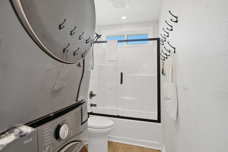 A bright full bathroom offers a tub and shower combination for an easy and comfortable stay.