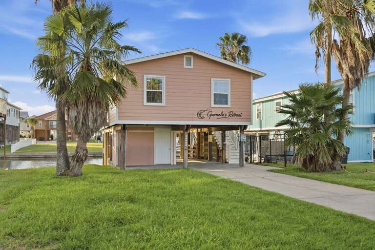 A charming canal-front retreat surrounded by palms and ready for your next coastal getaway.