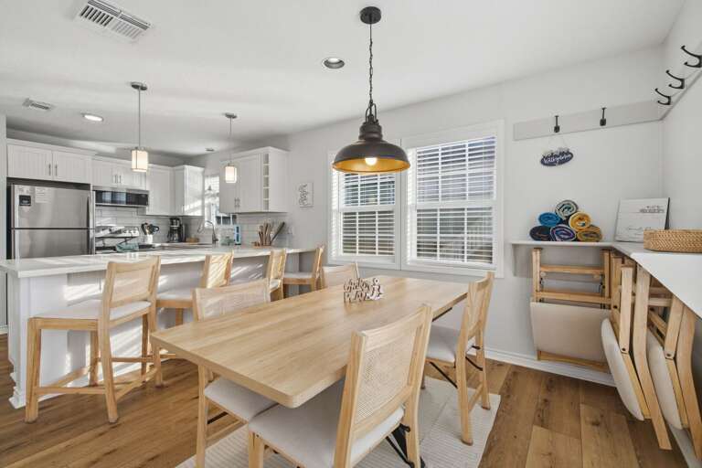 Enjoy meals, games, and time together around the spacious dining table just steps from the kitchen.