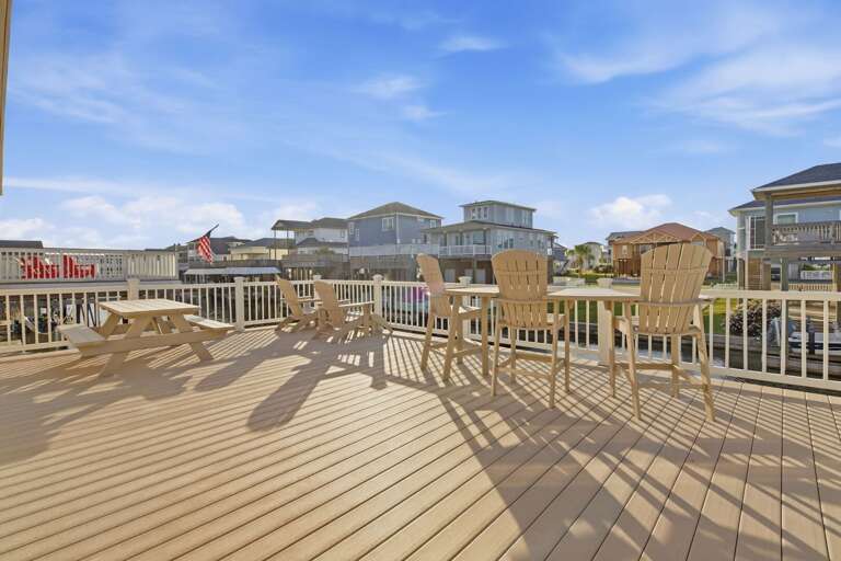 The expansive deck offers plenty of seating and space to gather, relax, and soak up the sunshine.