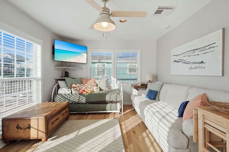Kick back and relax in the comfortable living room, filled with natural light and coastal charm.