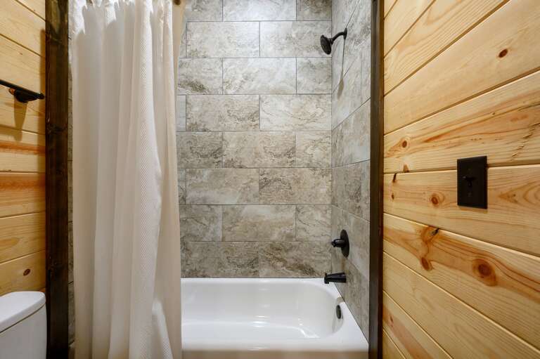 Shower / tub combo and sliding door privacy to vanity area.