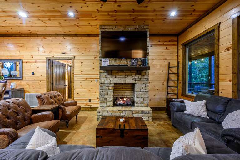 Living room with fireplace and 65' Smart TV, Sonos sound bar.
