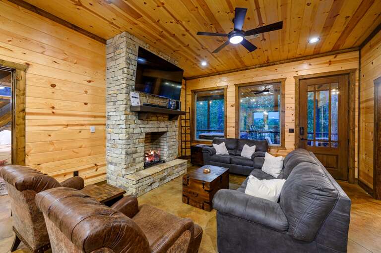 Living room with fireplace and 65' Smart TV, Sonos sound bar.