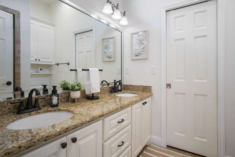 One of the private bathrooms contains double vanity and shower.