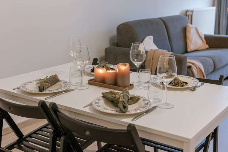 Dining Table Set For Supper, Sofa In Background