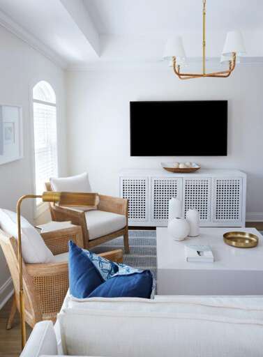 White-walled Living Space With Wood Accents And Mounted TV