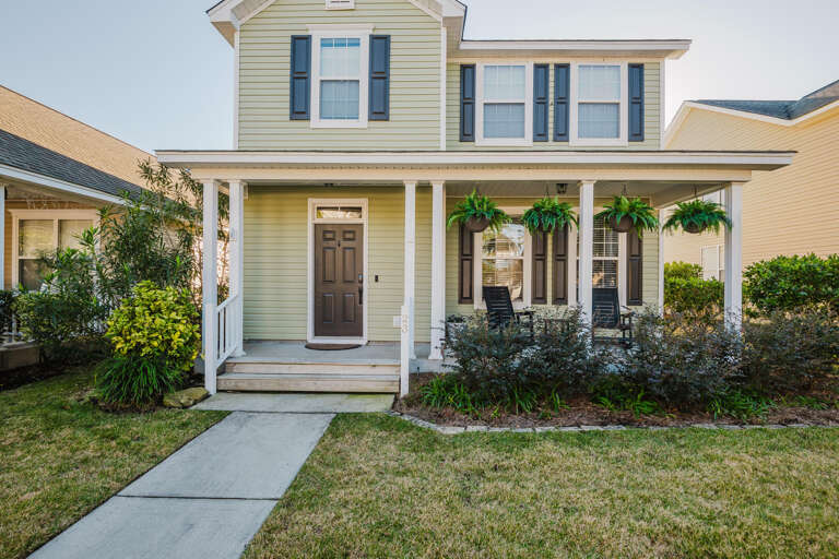 Suburban Structure With Sunlit Siding, Verdant Vegetation, Leading Path