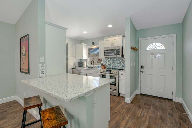 Fully Equipped Stainless Steel Kitchen w/ Bar Seating