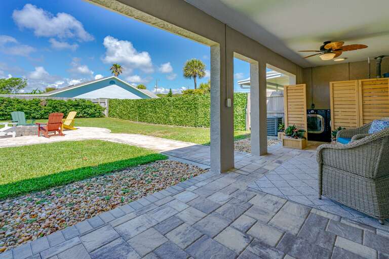 Island Time Fenced Backyard w/ Couches and Adirondack Chairs
