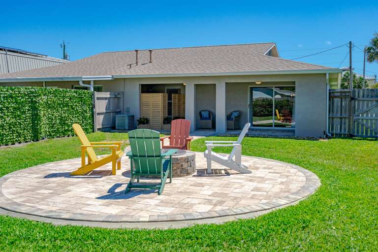 Island Time Fenced Backyard w/ Couches and Adirondack Chairs