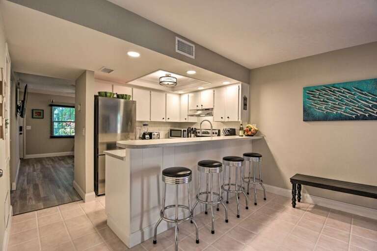 Fully Equipped Stainless Steel Kitchen with Bar Seating