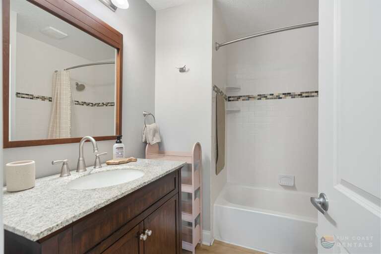 Full Bathroom with granite and tub/shower combo