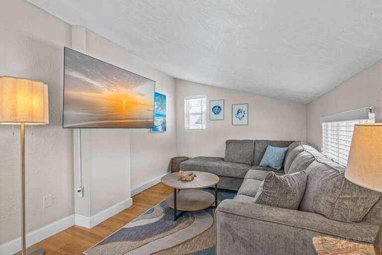 Upstairs landing with game area, ample lounging space, and queen pullout bed!