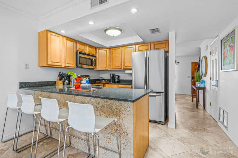 Fully-Equipped Stainless Steel Kitchen with Bar Seating