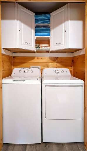 Full-size washer and dryer, complete with provided Tide Pods and dryer sheets.
