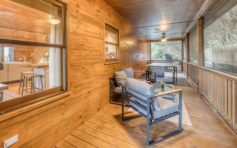 Side porch w/ sitting area and ping pong table