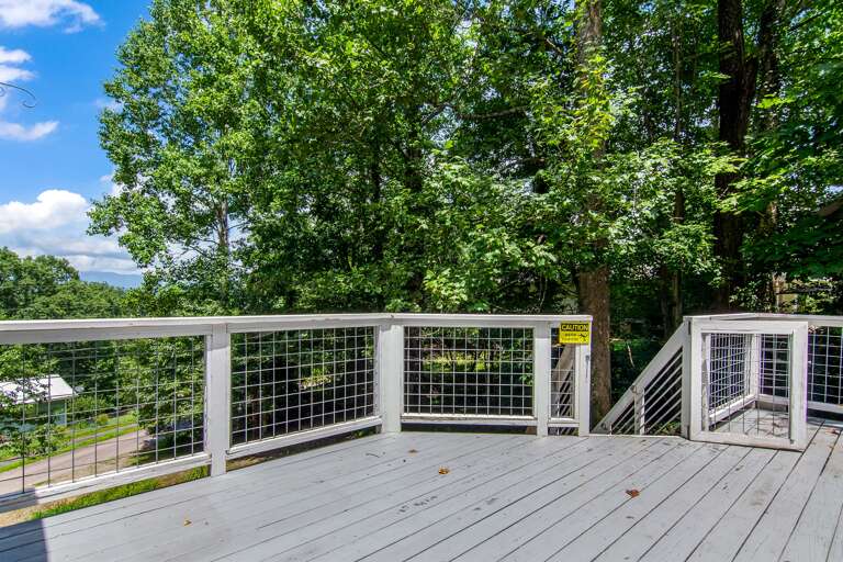 Relax and unwind on this peaceful deck surrounded by nature—perfect for outdoor dining or morning coffee.