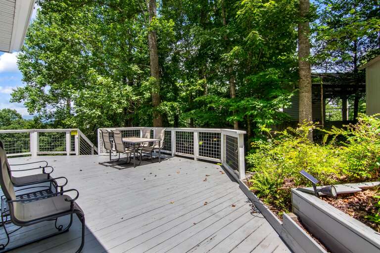 Relax and unwind on this peaceful deck surrounded by nature—perfect for outdoor dining or morning coffee.