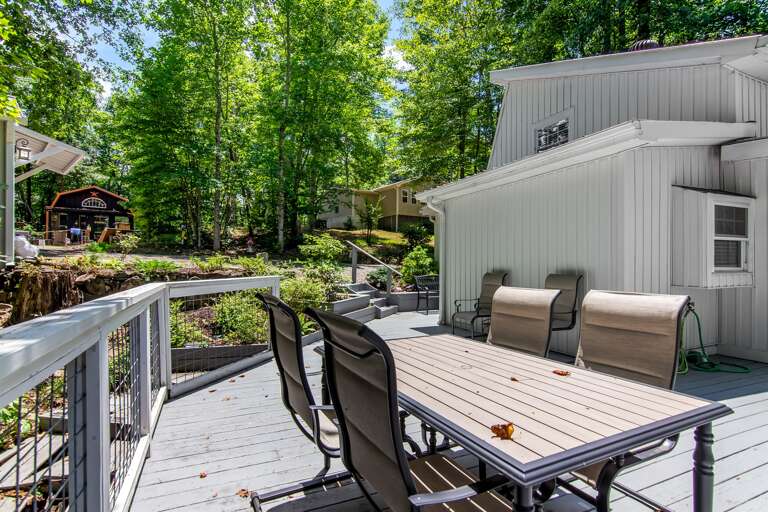 Relax and unwind on this peaceful deck surrounded by nature—perfect for outdoor dining or morning coffee.