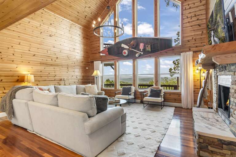 Living room w/ wall of windows and views of mens Living room w/ wall of windows and views of mens