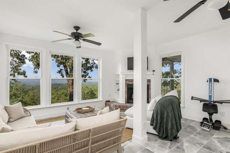 Secondary living room in upstairs w/ fireplace and smart TV-- wall of windows w/ gorgeous views