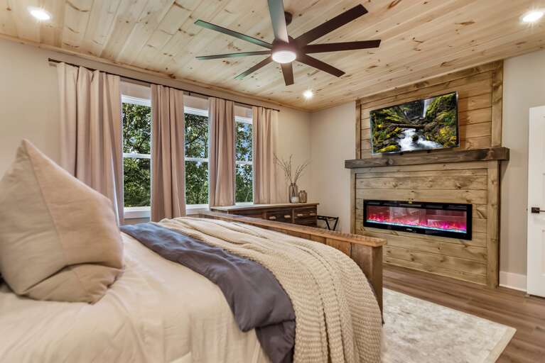 Primary bedroom w/ electric fireplace 