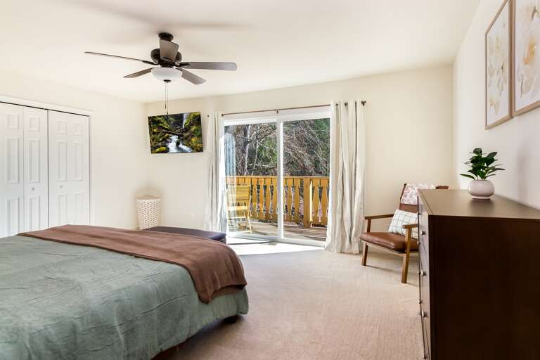 Master bedroom w/ sliding glass doors leading out to the balcony